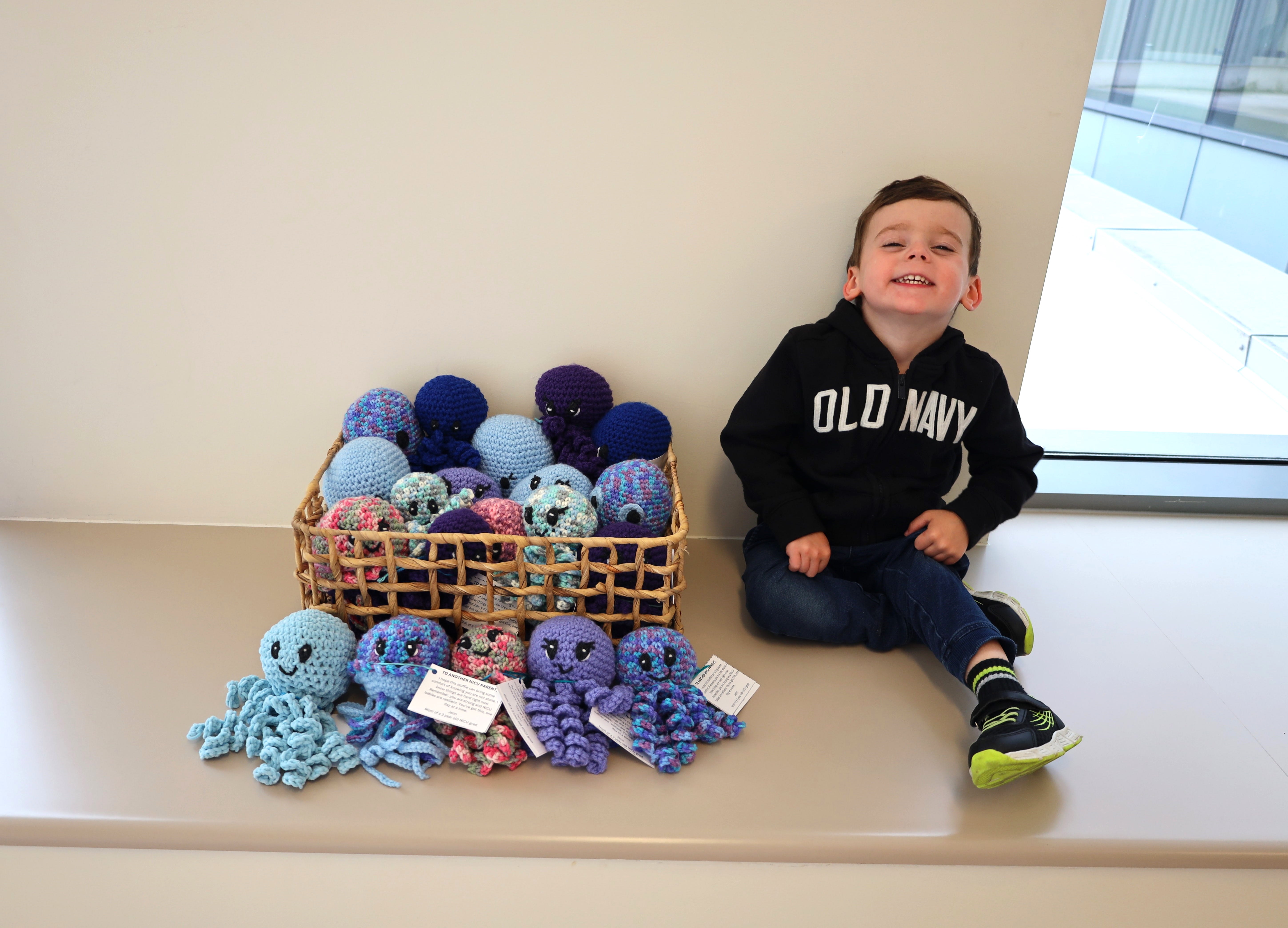 Theo Marinelli is all smiles beside the basket of toys his mom crocheted as a recent donation to Niagara Health’s NICU. Theo was born at 34 weeks and spent the first 30 days of his life in the NICU.