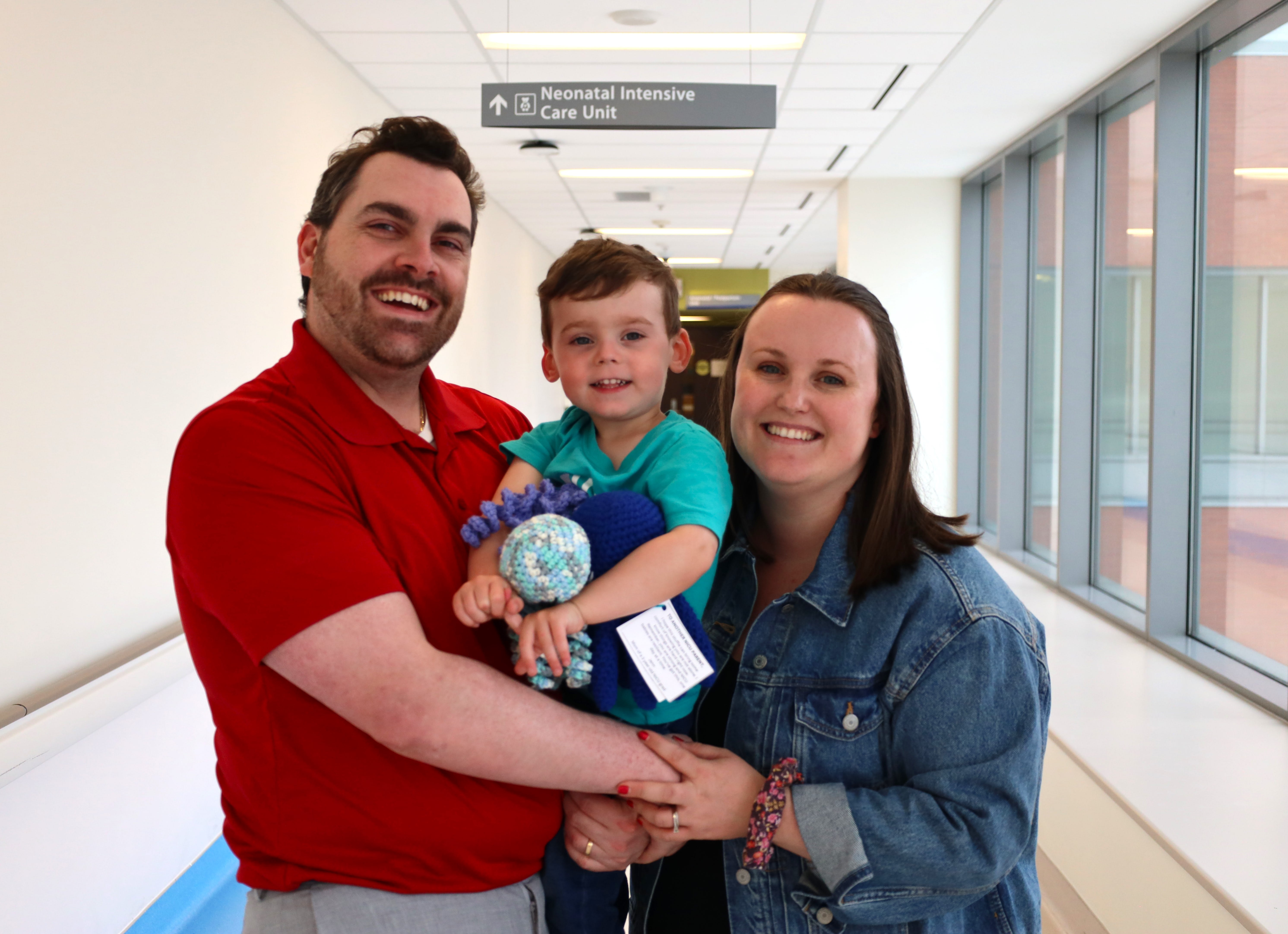 Joe and Jenn Marinelli hold their son, Theo, outside the doors of the neonatal intensive care unit at the Marotta Family Hospital in St. Catharines. Jenn recently donated octopus toys she crocheted to provide some comfort to patients and their families in the NICU.