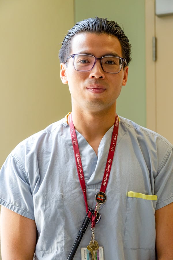 Headshot of Dr. Ben Tam. He is wearing scrubs and has a stethoscope around his neck.