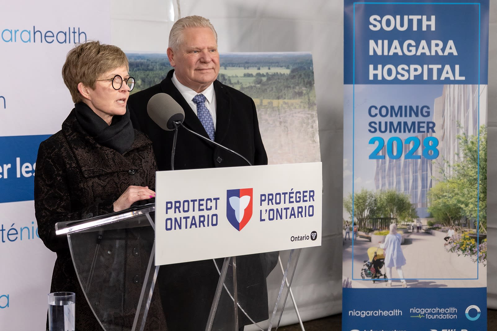 President and CEO of Niagara Health Lynn Guerriero speaks at a press conference celebrating the placing of one of the final beams in the construction of the South Niagara Hospital, alongside Premier Doug Ford.