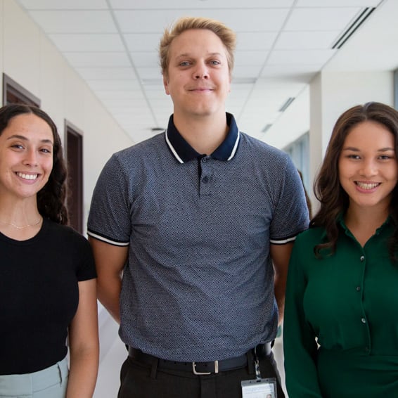 Three scholarship recipients stand together