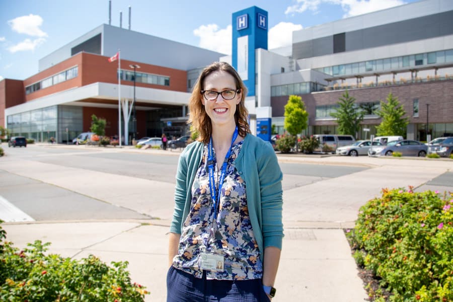 General Surgeon Dr. Stephanie Phillips stands outside the St. Catharines Hospital on a sunny day.